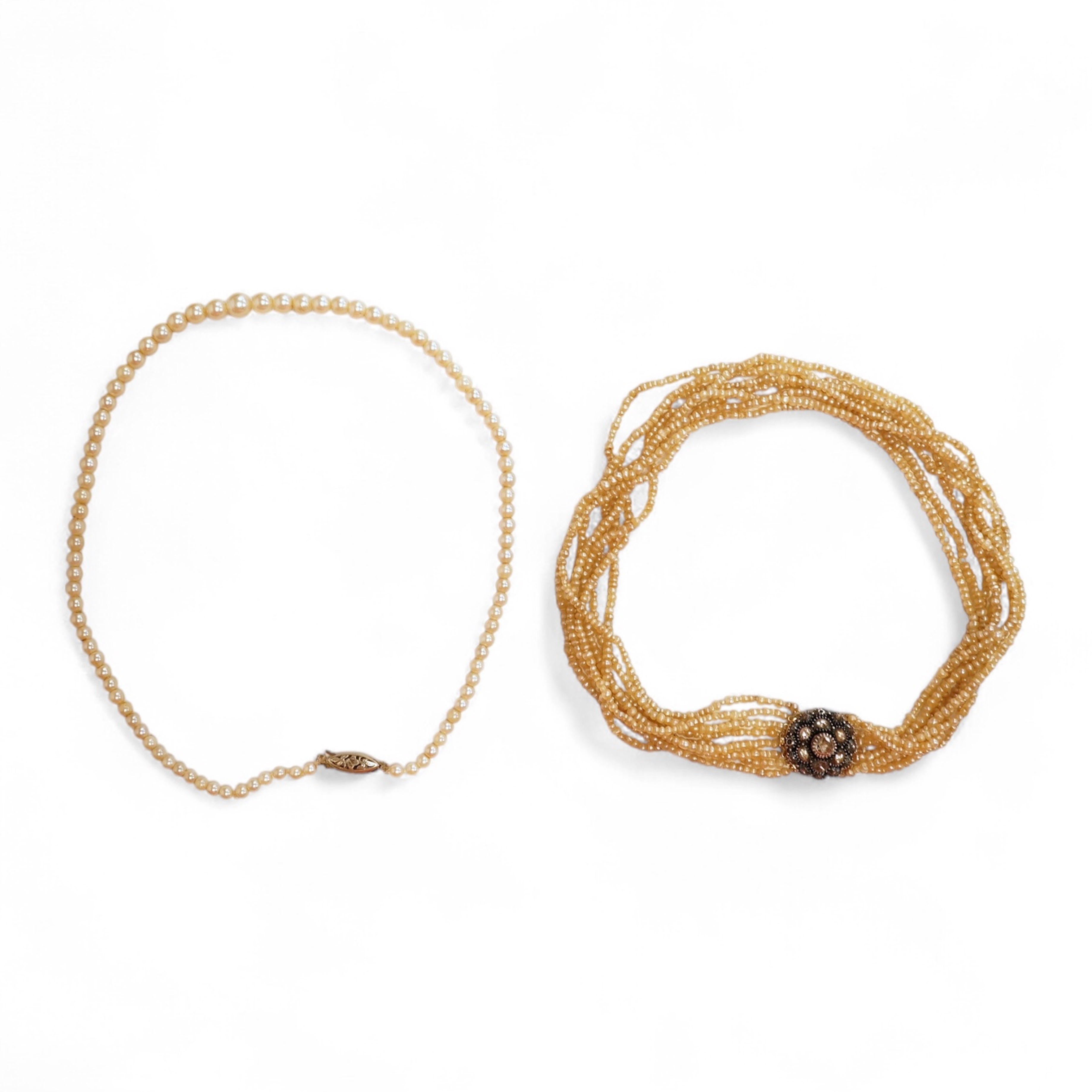 An eight-strand seed pearl choker necklace, with a rose-cut diamond clasp, length 34cm, pearls untested; together with a single strand graduated cultured pearl necklace, length 40cm, clasp stamped 9ct, Condition: good, s